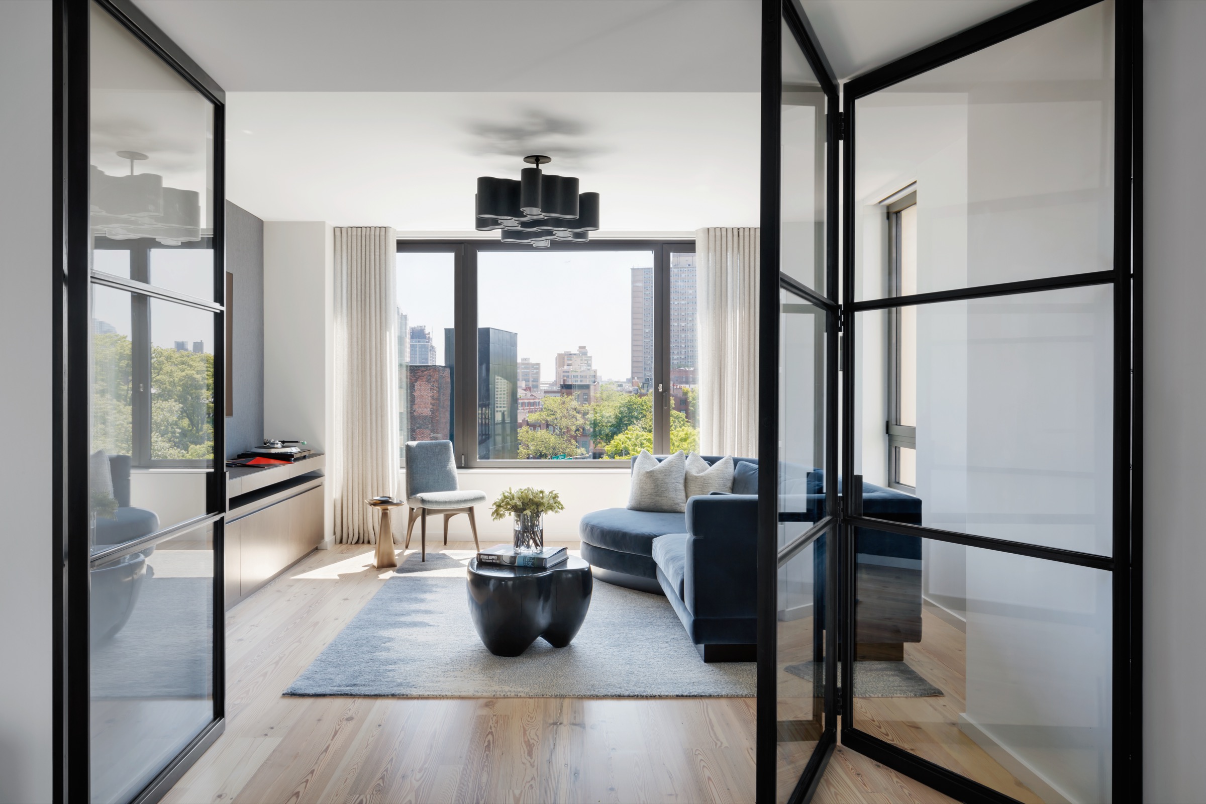 Listening room with glass doors and city views