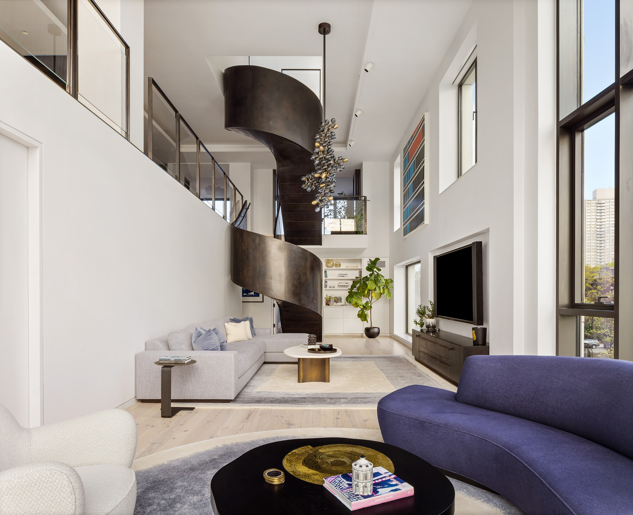 Double-height living room with BELT Atelier staircase