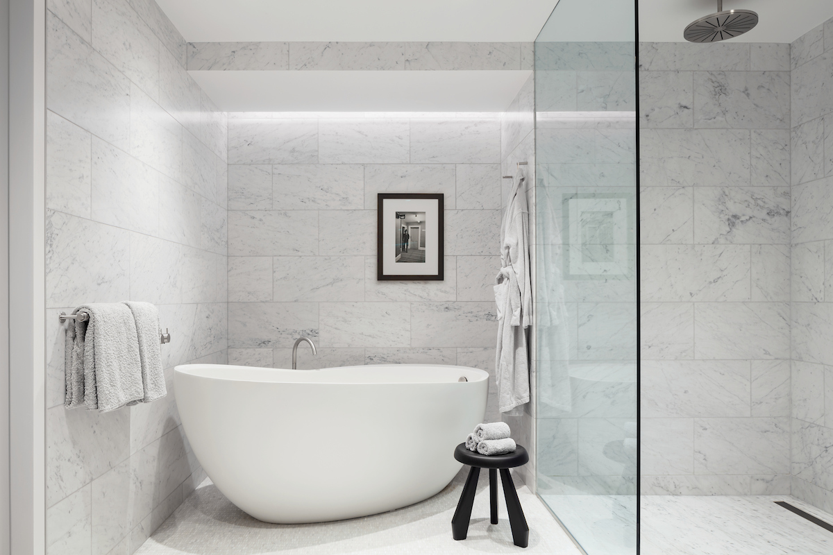 Primary bathroom with freestanding soaking tub and marble